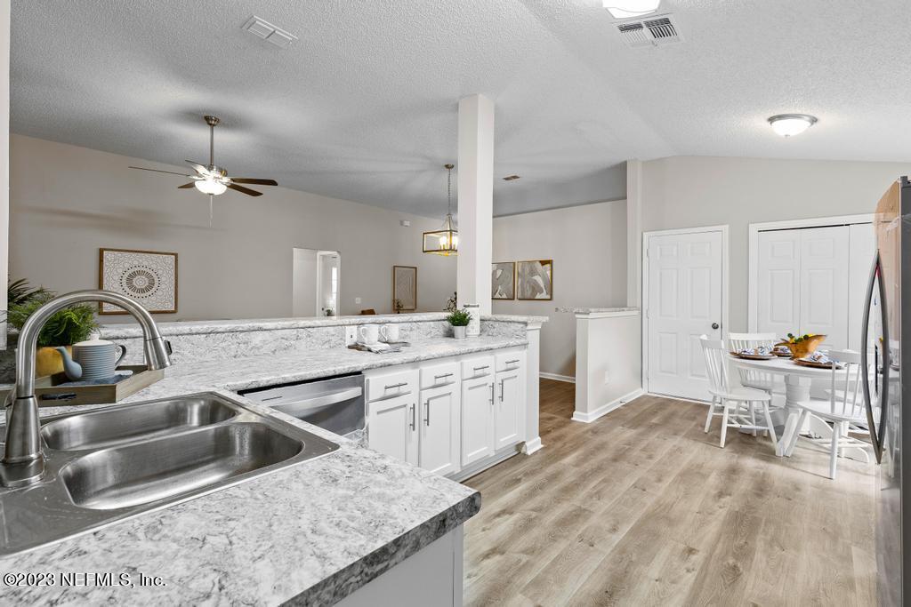 1652 Spring Oaks Lane Jacksonville, FL 32221 - Photo 19 of 37 a kitchen with a sink stove and wooden cabinets