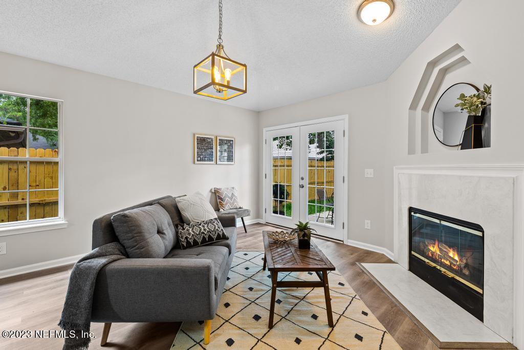 1652 Spring Oaks Lane Jacksonville, FL 32221 - Photo 21 of 37 a living room with furniture a window and a fireplace