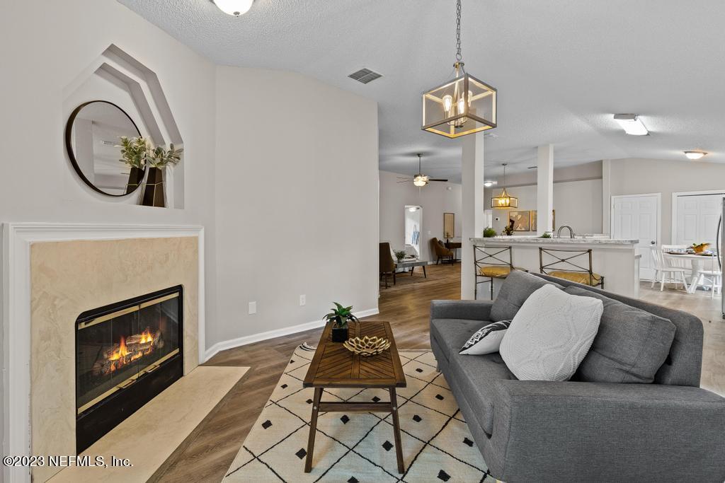 1652 Spring Oaks Lane Jacksonville, FL 32221 - Photo 22 of 37 a living room with furniture and a fireplace
