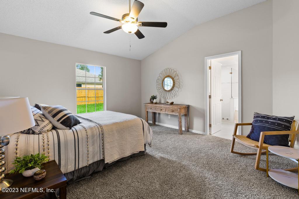 1652 Spring Oaks Lane Jacksonville, FL 32221 - Photo 27 of 37 a bed room with a bed and a chandelier