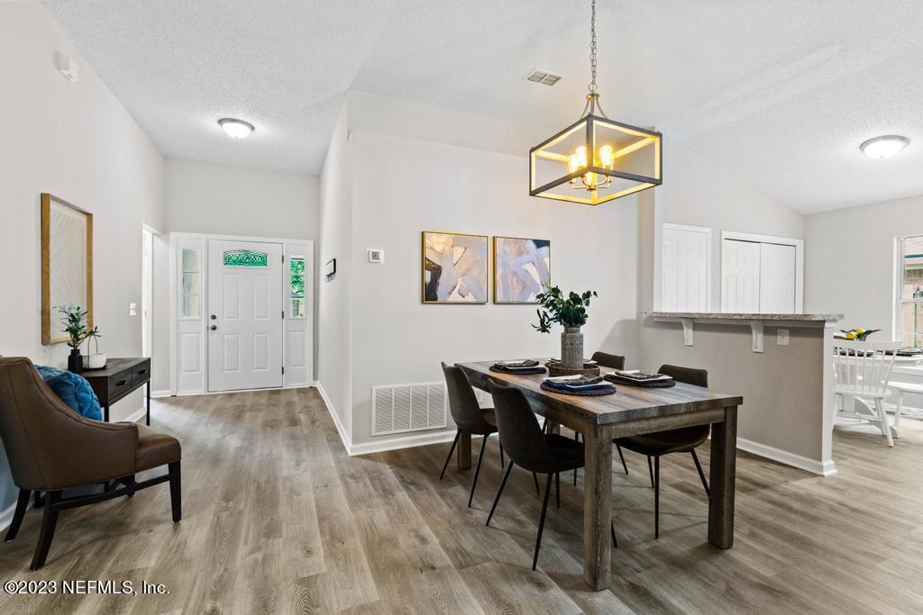 1652 Spring Oaks Lane Jacksonville, FL 32221 - Photo 6 of 37 a view of a dining room with furniture and wooden floor