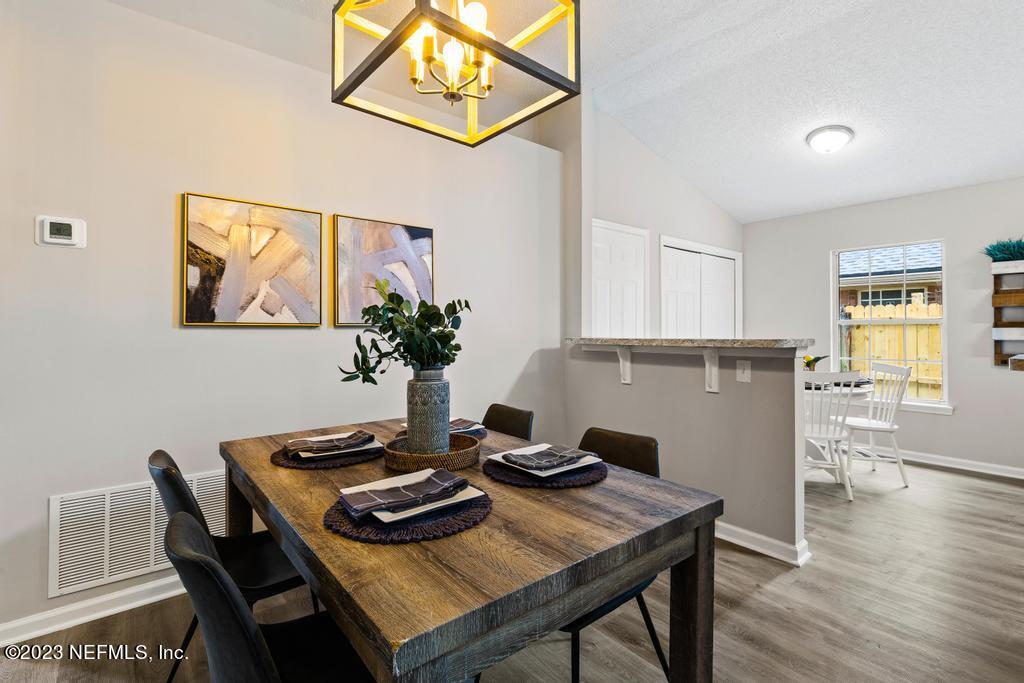 1652 Spring Oaks Lane Jacksonville, FL 32221 - Photo 7 of 37 a view of a dining room with furniture and wooden floor