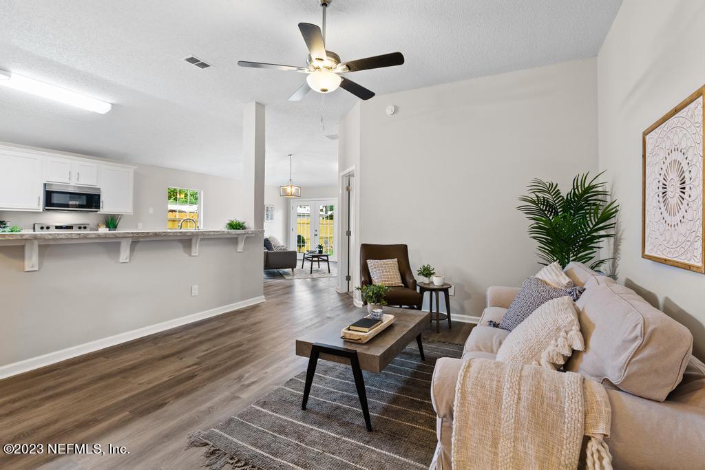 1652 Spring Oaks Lane Jacksonville, FL 32221 - Photo 9 of 37 a living room with furniture and a chandelier