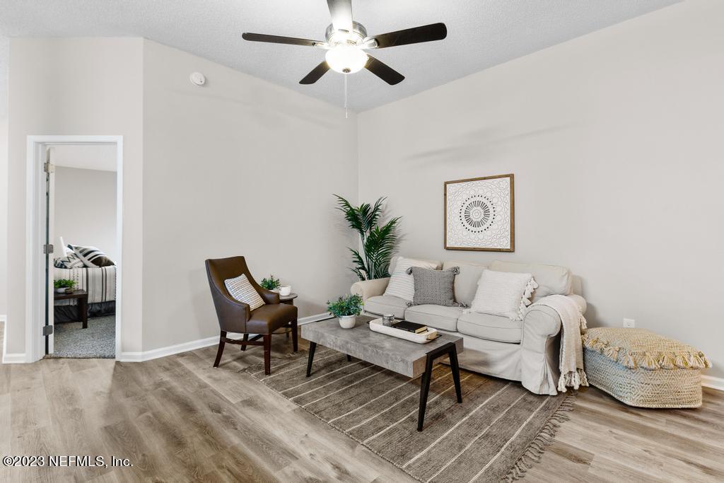 1652 Spring Oaks Lane Jacksonville, FL 32221 - Photo 10 of 37 a living room with furniture and a chandelier