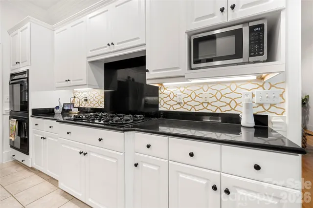 a spacious bathroom with a double vanity sink a mirror and a shower