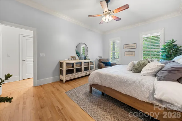 a bedroom with furniture and a large window