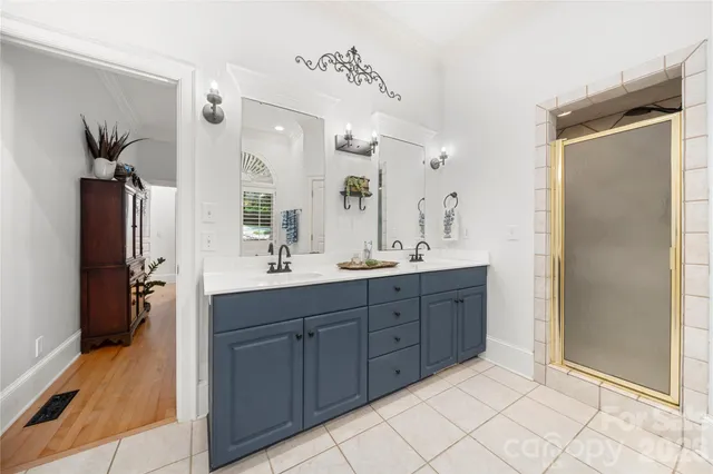 a front view of a house with a garden and trees