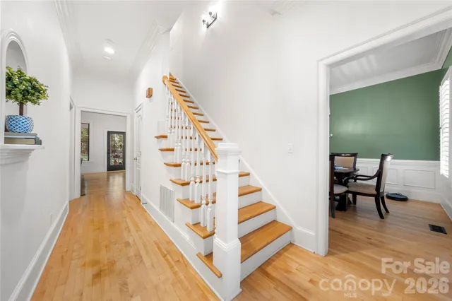 a view of entryway with wooden floor and stairs