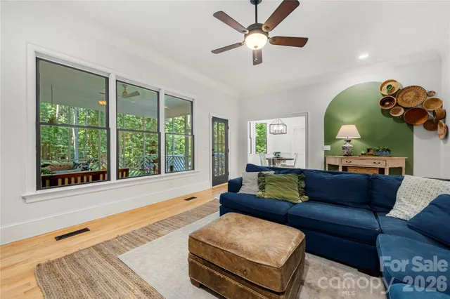 a living room with furniture fireplace and flat screen tv