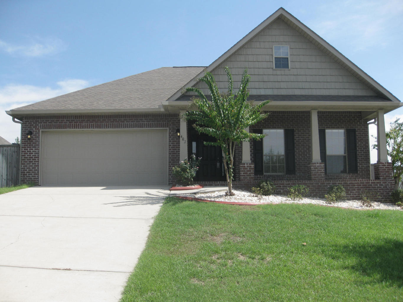 402 Wych Circle Crestview, FL 32536 - Photo 1 of 17 a front view of a house with a yard and garage