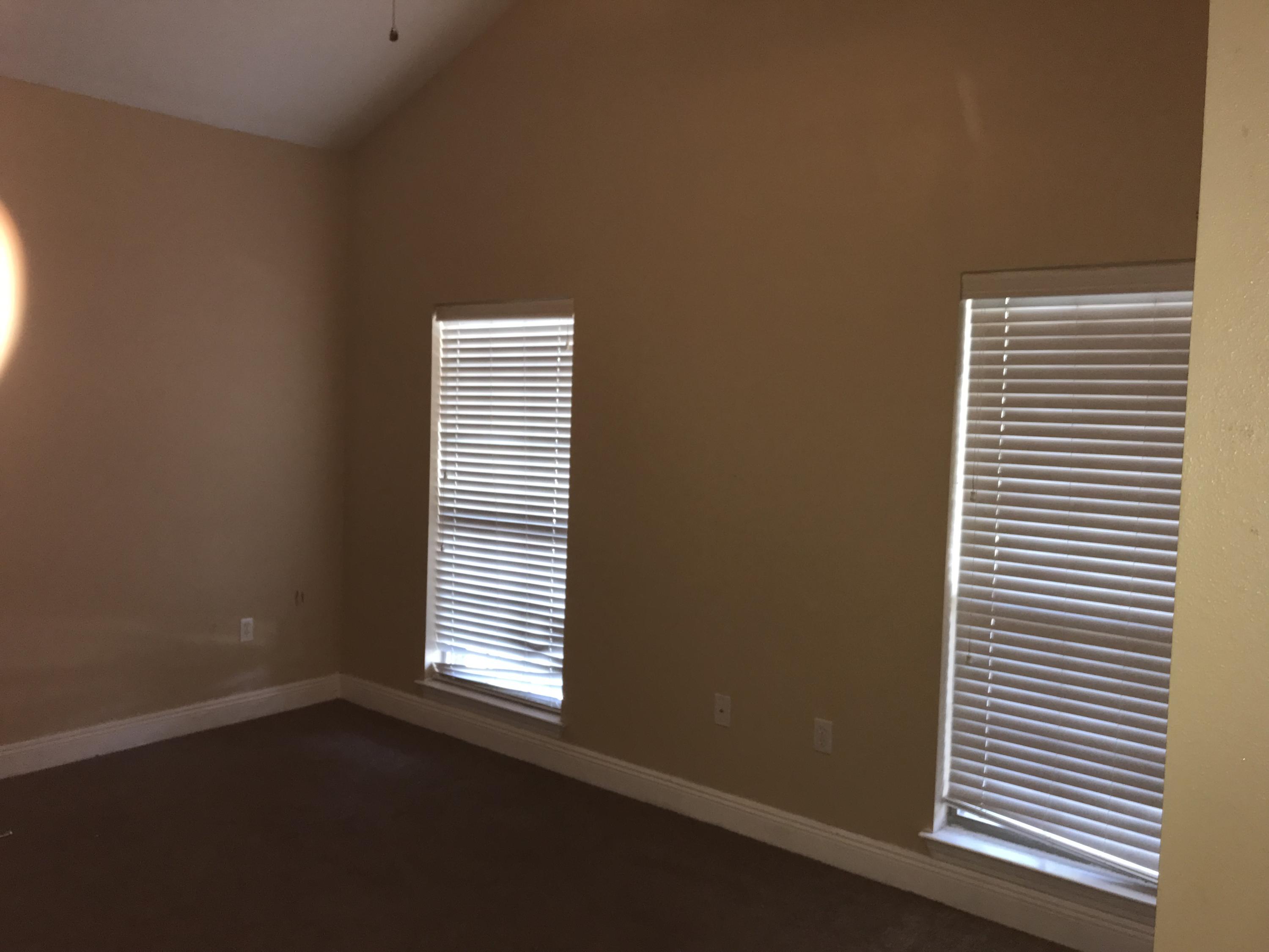 402 Wych Circle Crestview, FL 32536 - Photo 11 of 17 an empty room with windows and painted walls