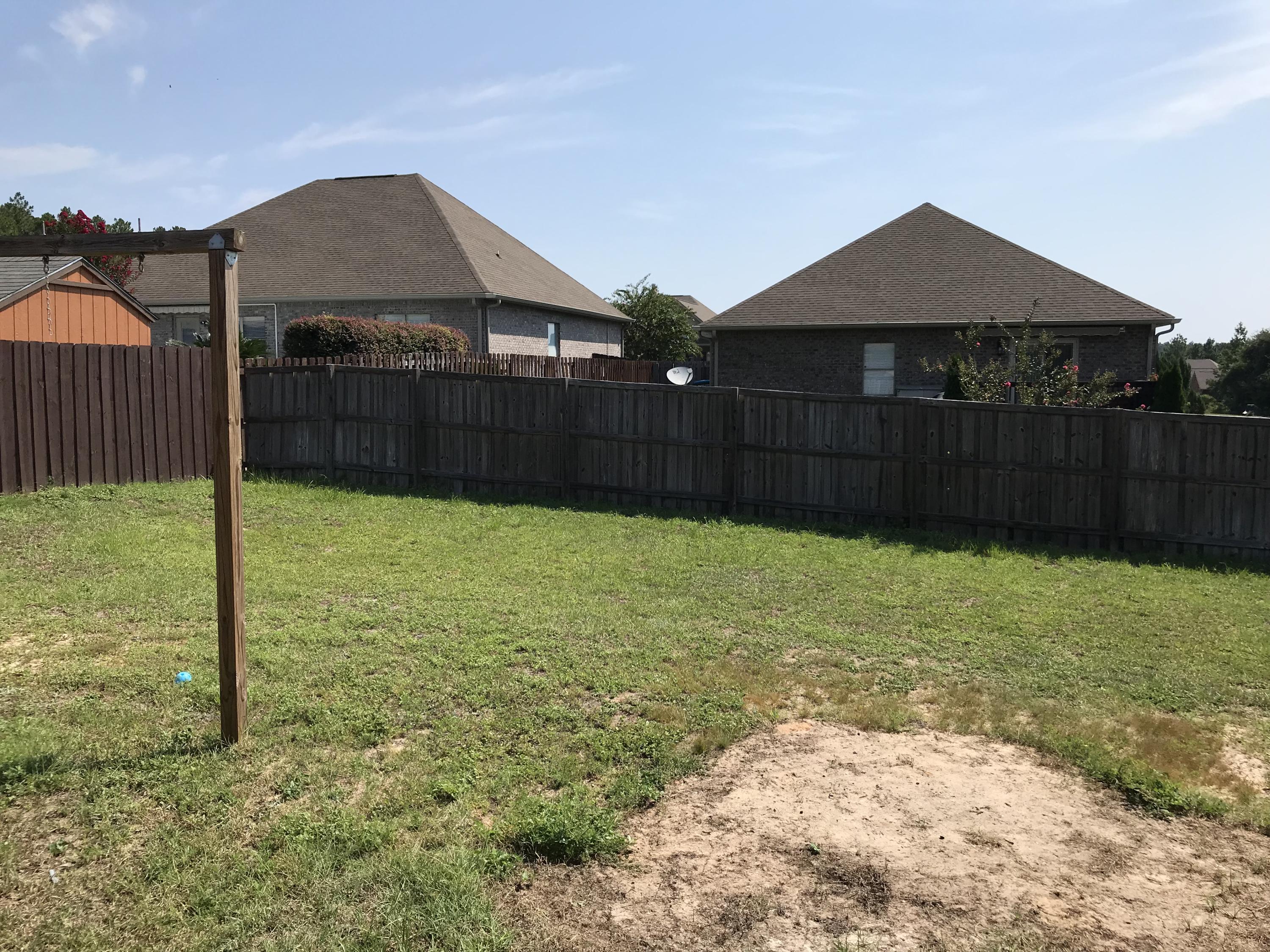 402 Wych Circle Crestview, FL 32536 - Photo 16 of 17 a front view of a house with a yard and fence