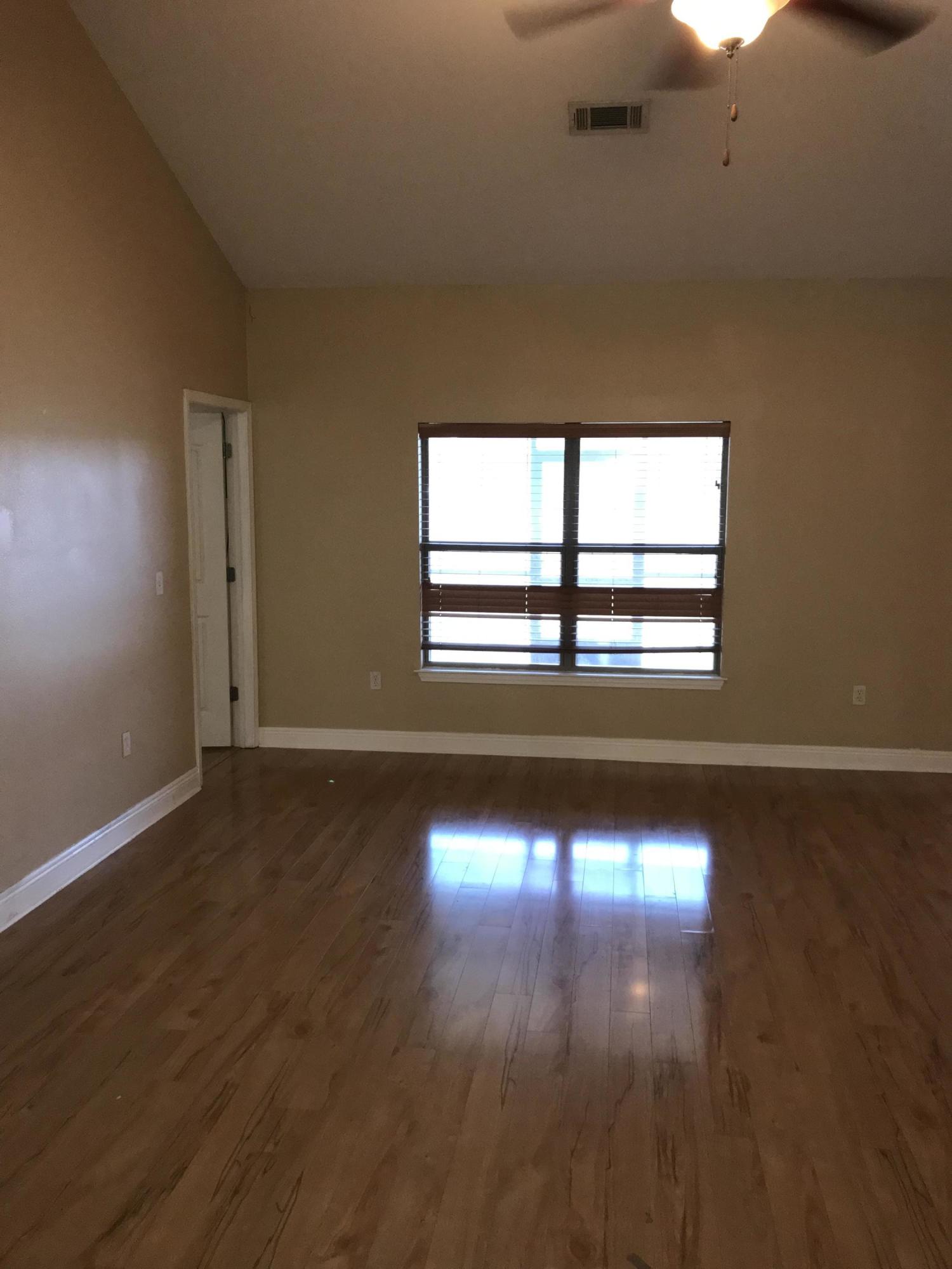 402 Wych Circle Crestview, FL 32536 - Photo 3 of 17 a view of empty room with wooden floor and fan