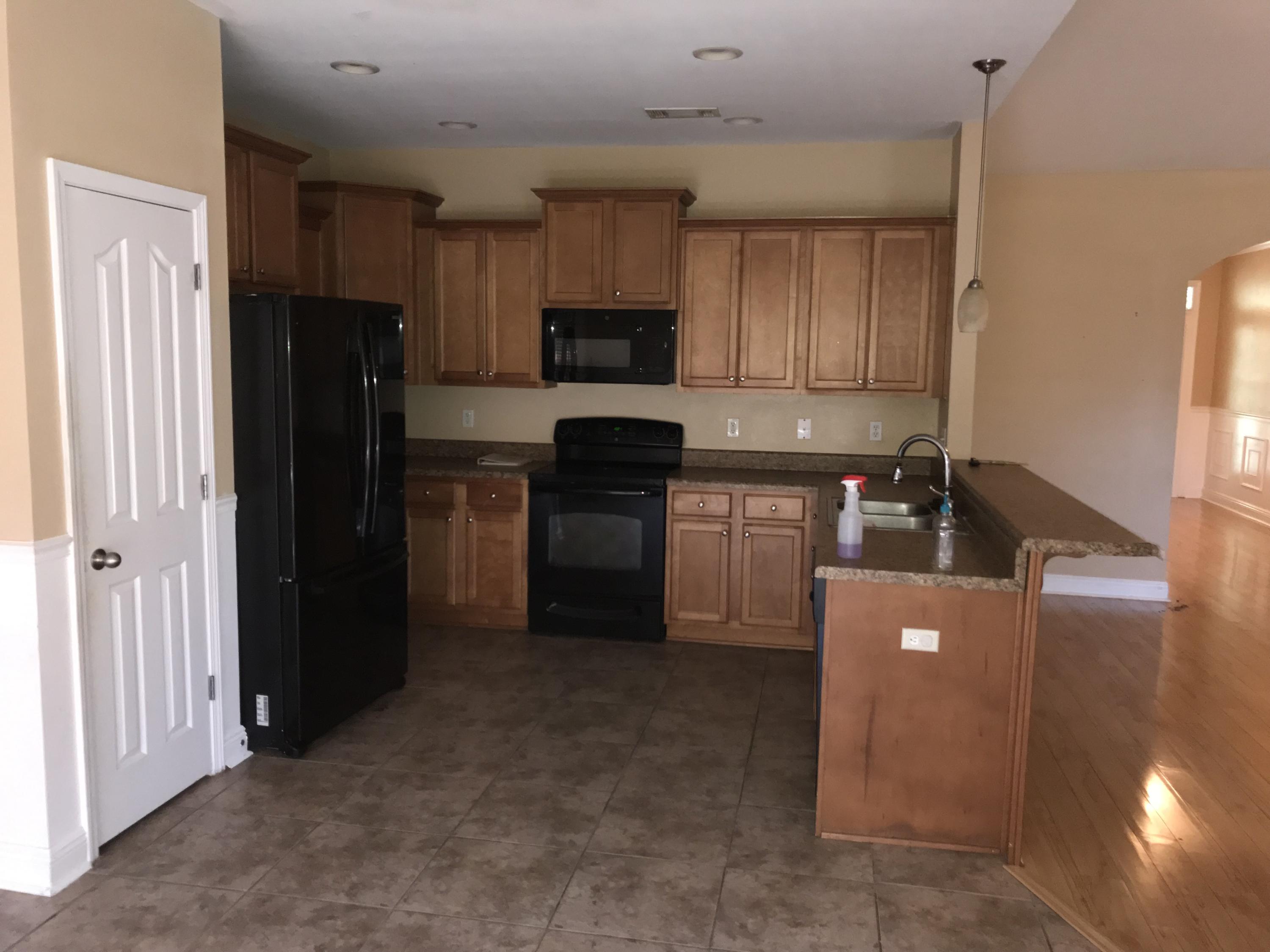402 Wych Circle Crestview, FL 32536 - Photo 4 of 17 a kitchen with stainless steel appliances granite countertop a refrigerator and a stove top oven