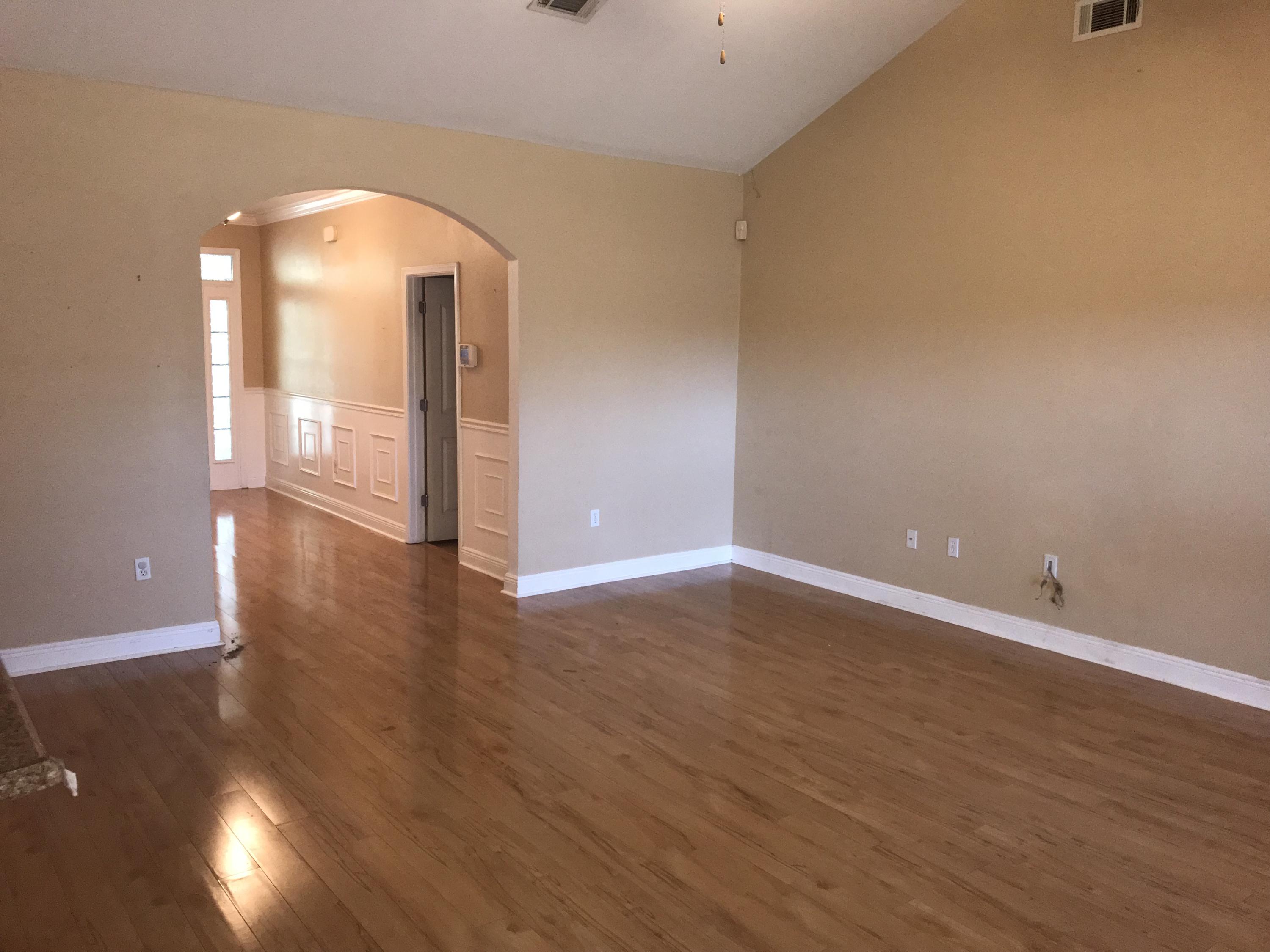 402 Wych Circle Crestview, FL 32536 - Photo 5 of 17 wooden floor in an empty room with a window
