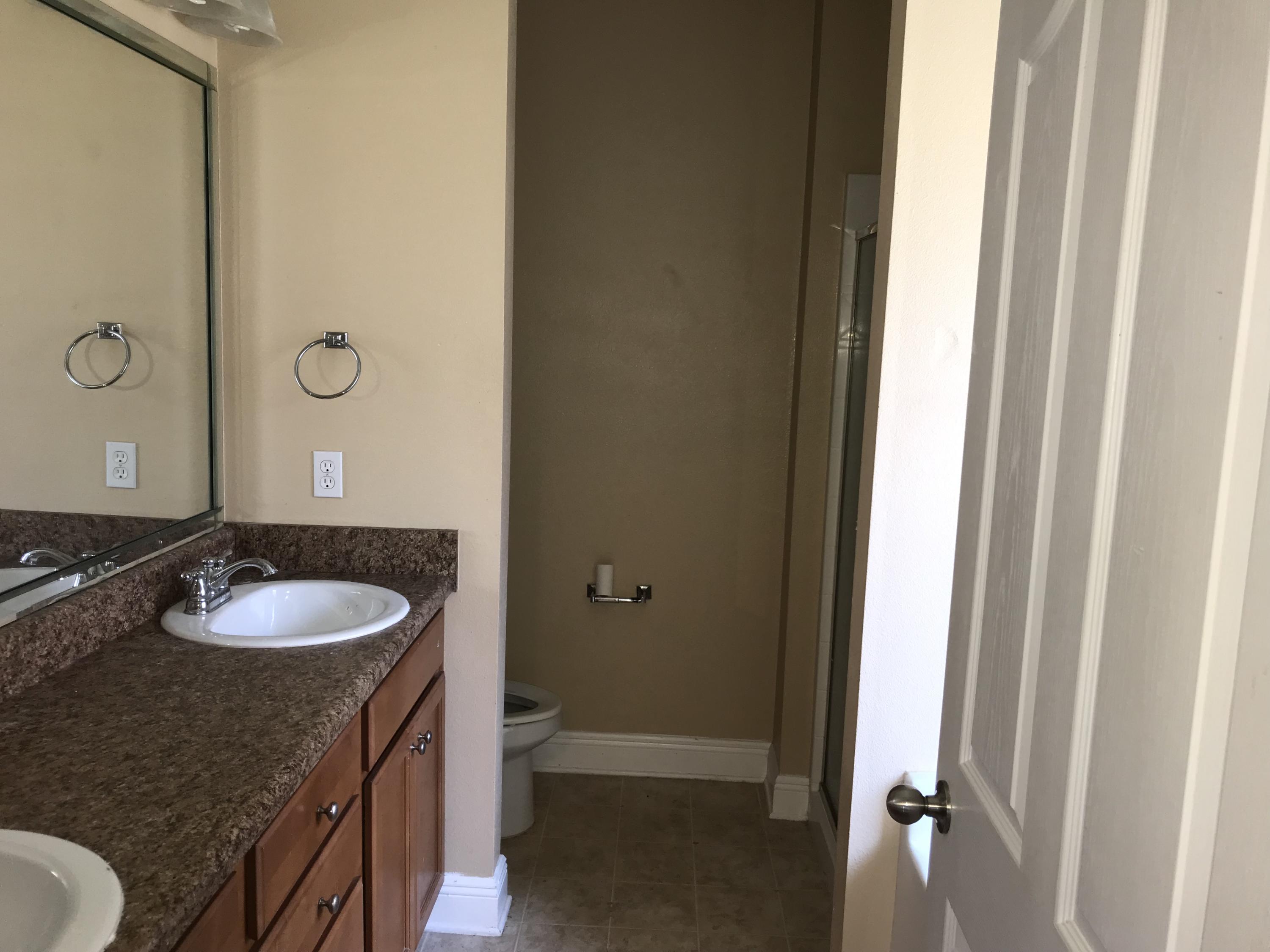 402 Wych Circle Crestview, FL 32536 - Photo 7 of 17 a bathroom with a granite countertop sink and a mirror