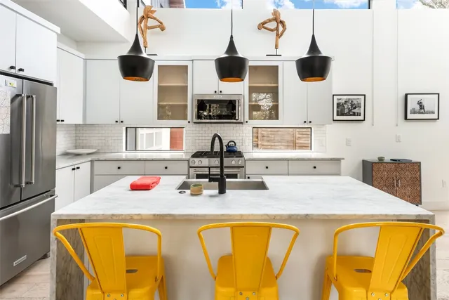 a kitchen with stainless steel appliances granite countertop a sink and cabinets