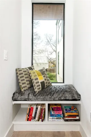 a living room with a couch and floor to ceiling window