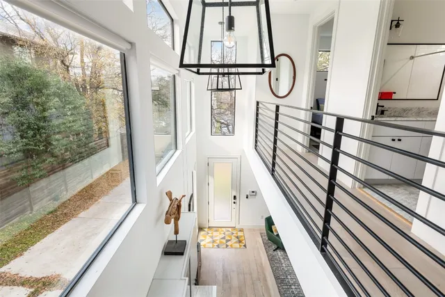 a view of staircase with wooden floor and window