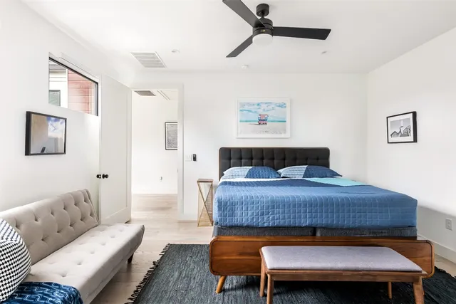 a bedroom with furniture and wooden floor