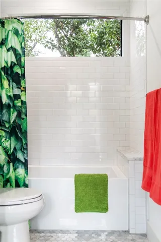 a bathroom with a toilet and a shower