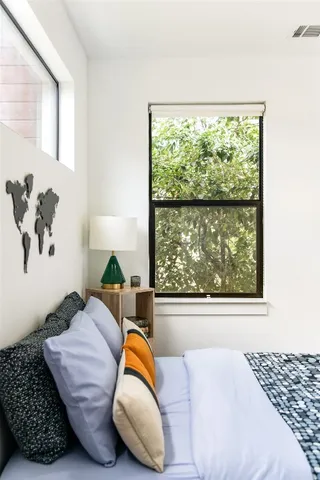 a bedroom with a bed and a window