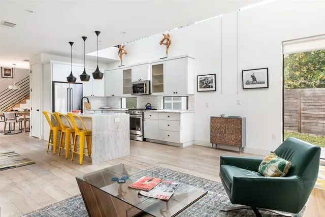 a living room with furniture and kitchen view