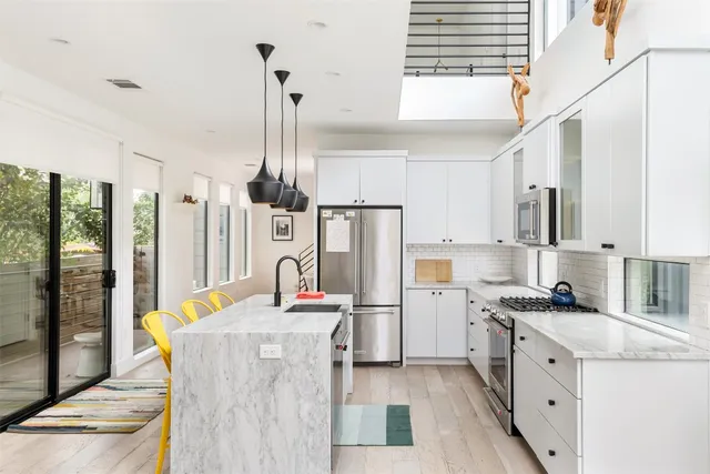 a kitchen with refrigerator cabinets and wooden floor