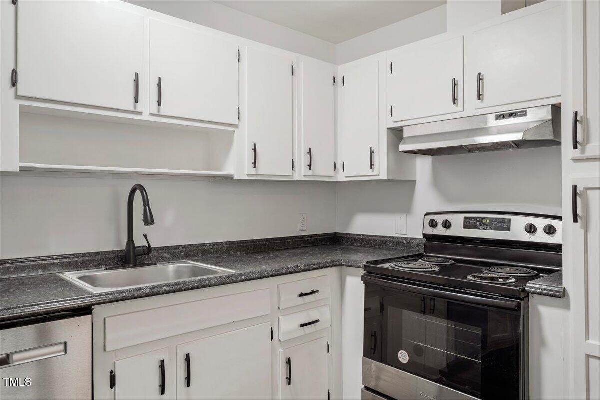 1621 Seminole Trail Raleigh, NC 27609 - Photo 11 of 25 a kitchen with granite countertop white cabinets and stainless steel appliances