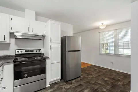 a kitchen with a stove and a refrigerator
