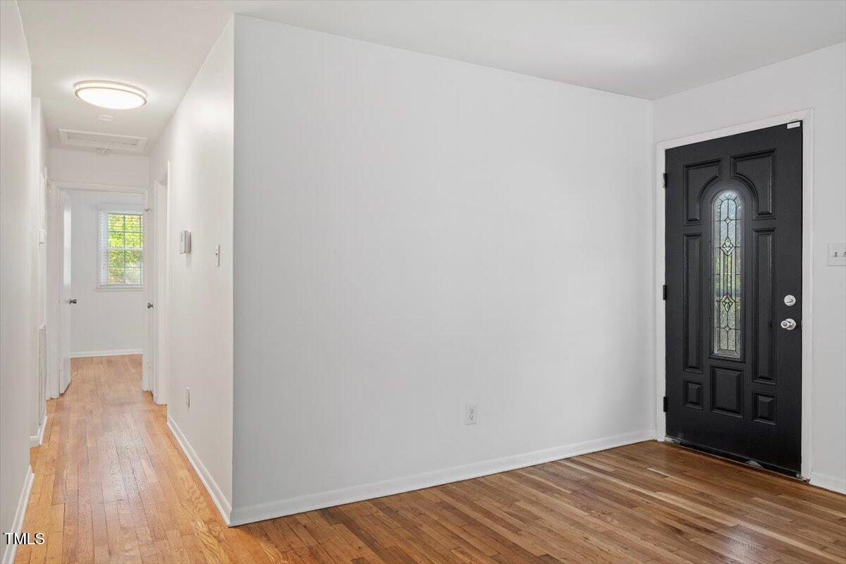 1621 Seminole Trail Raleigh, NC 27609 - Photo 13 of 25 a view of a room with wooden floor and a bathroom