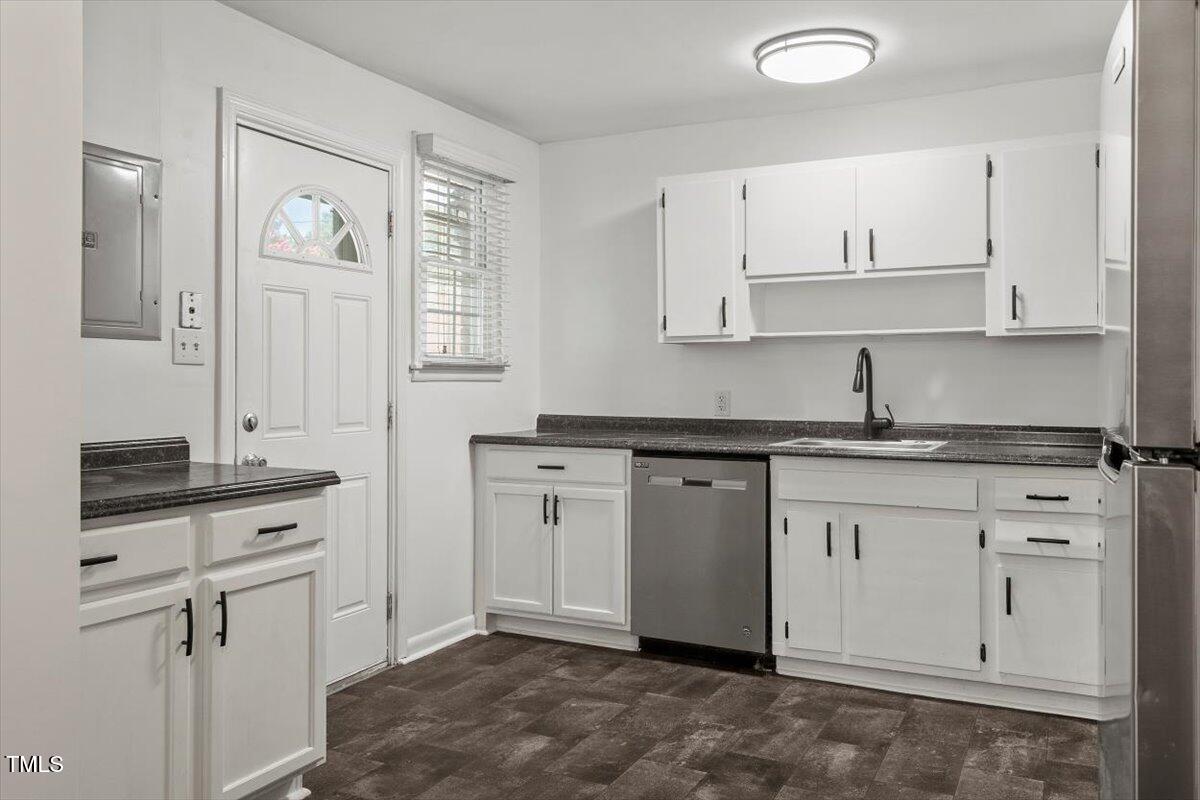 1621 Seminole Trail Raleigh, NC 27609 - Photo 9 of 25 a kitchen with granite countertop white cabinets white stainless steel appliances with a sink and dishwasher