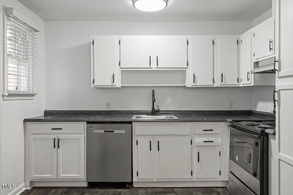 1621 Seminole Trail Raleigh, NC 27609 - Photo 10 of 25 a kitchen with granite countertop white cabinets and a stove