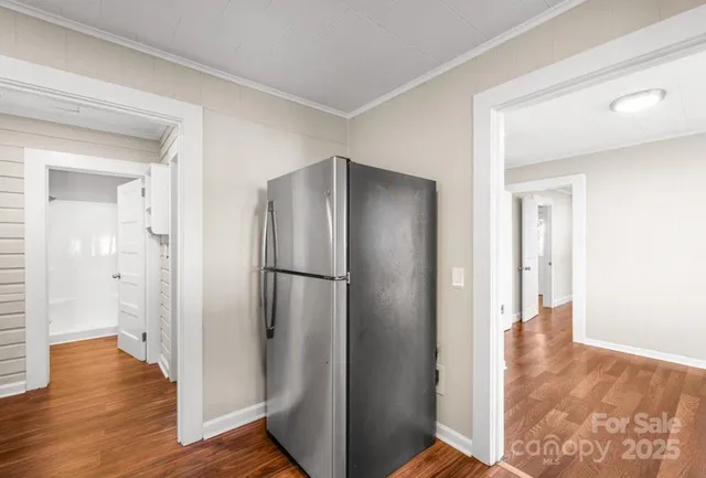 a view of hallway with wooden floor