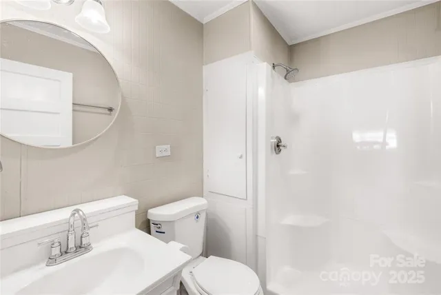 a white toilet sitting next to a bathroom sink