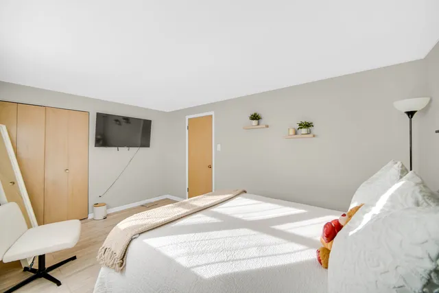 a bathroom with a sink a mirror a toilet and a window