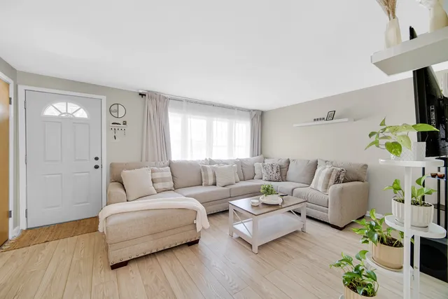 a kitchen with stainless steel appliances a table and chairs in it