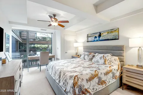 a bedroom with a large bed and a chandelier