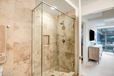 a bathroom with a shower and a sink