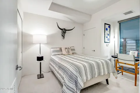 a bedroom with a bed and a chandelier