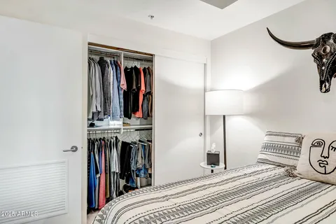 a view of a bedroom with wooden floor and shoes