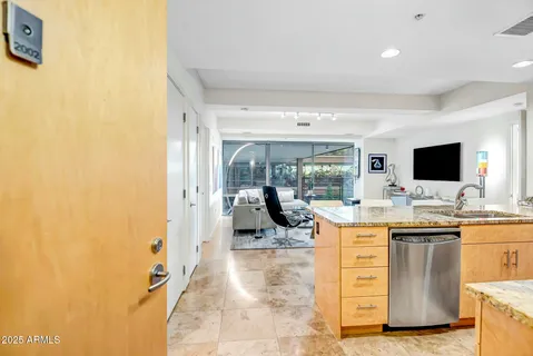 a view of a kitchen with kitchen island a counter top space and a sink