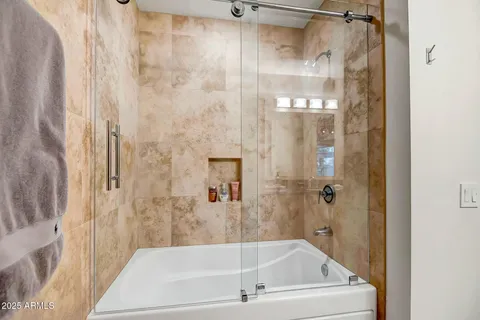 a bathroom with a tub and shower