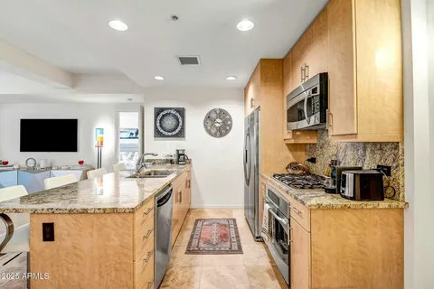 a kitchen with stainless steel appliances granite countertop a stove and a sink