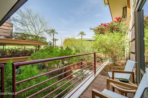 a view of a balcony with wooden chairs