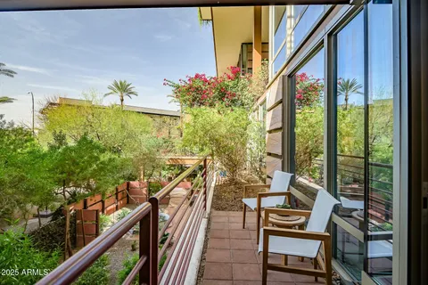 a balcony view with couple of chairs