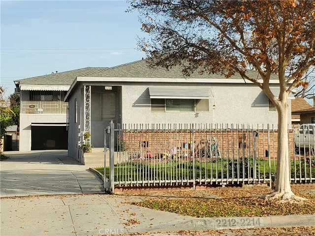 a view of a house with a iron gate