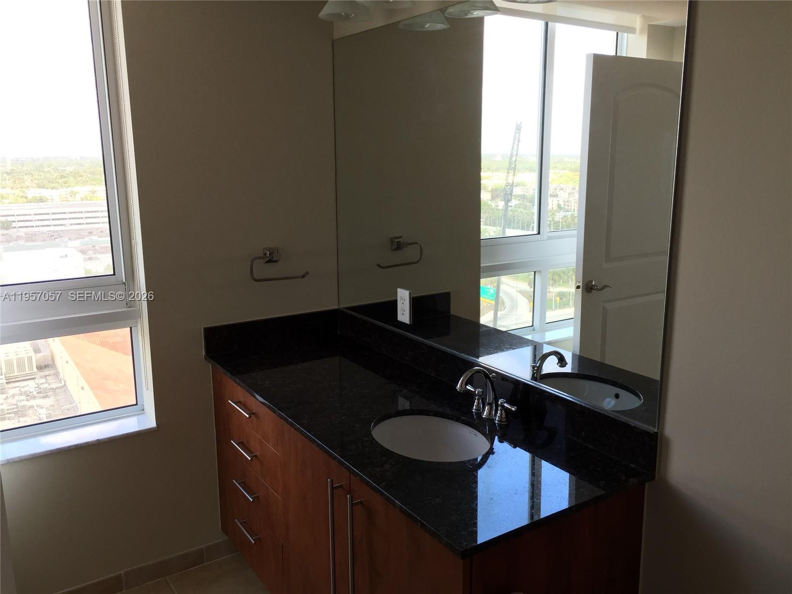 7350 Southwest 89th Street, Unit 1611S Miami, FL 33156 - Photo 6 of 16 a bathroom with a sink and a mirror