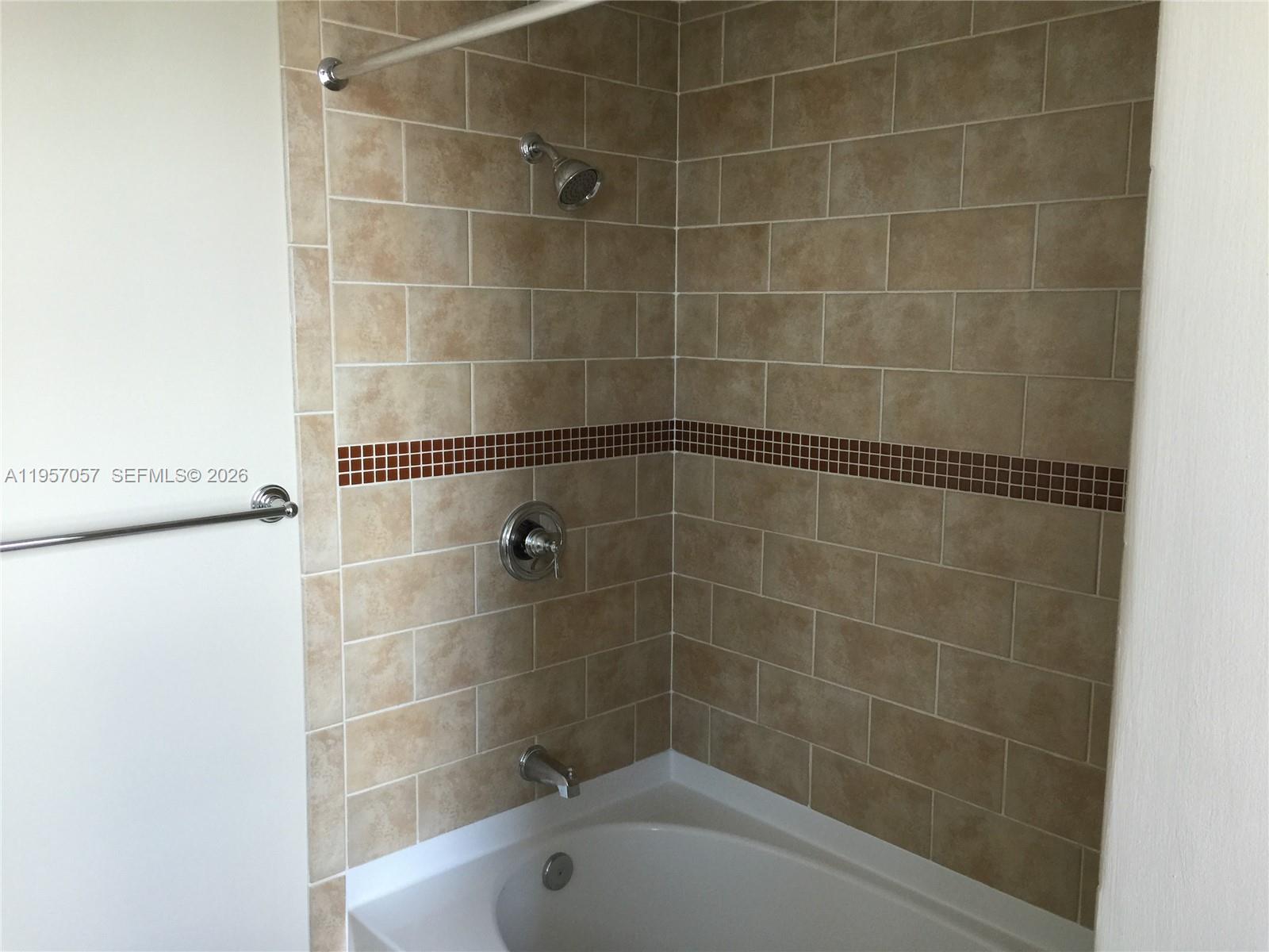 7350 Southwest 89th Street, Unit 1611S Miami, FL 33156 - Photo 7 of 16 a bathroom with a bathtub