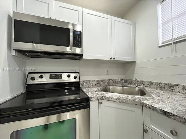 a kitchen with a stove and a microwave